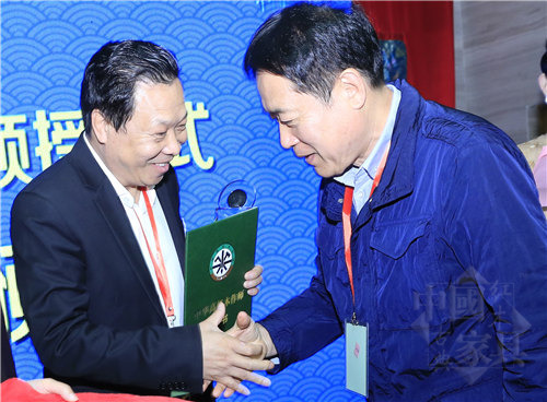 01中华木工委专家委员会主任张德祥(右)为曹兆庭(左)颁授“中华高级木作师”荣誉